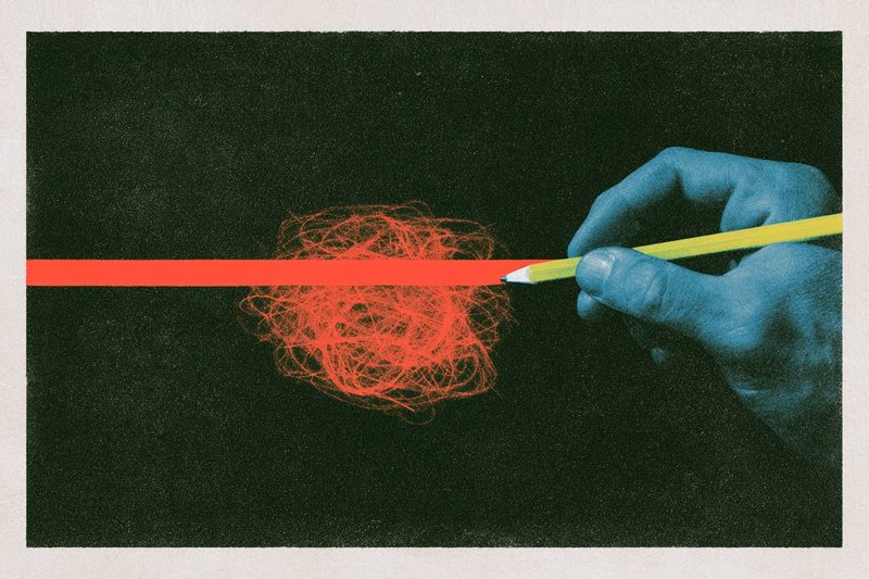 A hand holding a pen over a line